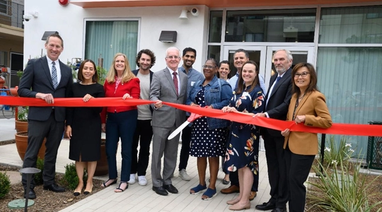 A photo of Council President Krekorian cutting the ribbon for NoHo 5050 Permanent Supportive Housing.