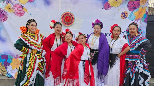 Latino Heritage Celebration dancers pose for the group photo.
