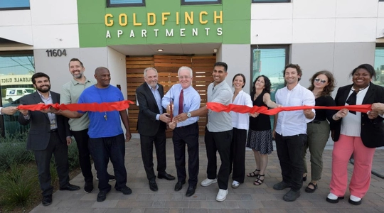 A picture of the ribbon cutting at the Goldfinch Apartments.