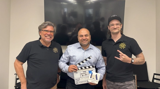 Councilmember Nazarian holds a production slate, standing with two members of IATSE B-192