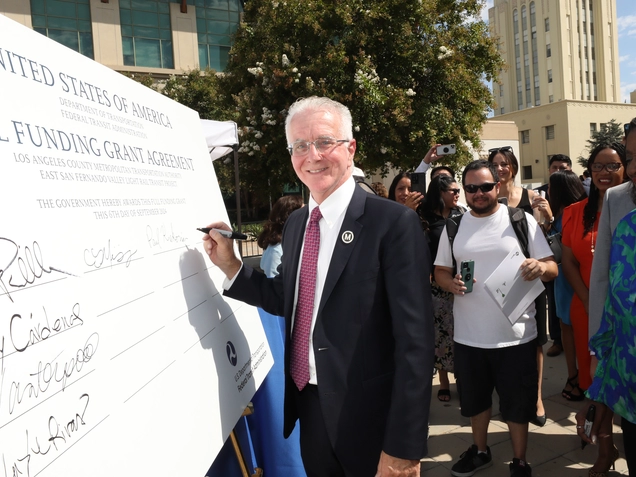 A photo of Councilmember Krekorian signing the ESFV check.