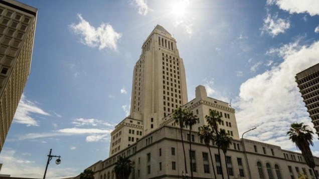 Exterior view of City Hall with the sun glaring at the pinnacle