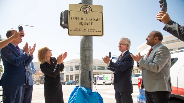 Councilmemer traci park, Coulncil president kreorian and former State Assemblymember Adrin Nazarian applaud as Artsakh Square sign is unveiled.