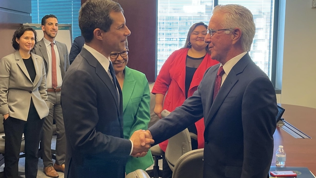 Secretary of Transportation Pete Buttigieg shakes hands with Council President Krekorian as Mayor Bass and other Councilmembers look on.