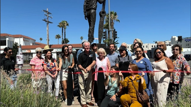 A photo of the ribbon cutting at the Amelia Earhart statue.