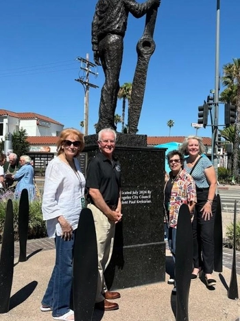 A photo of Councilmember Krekorian in front of the statue.