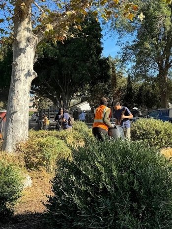 Volunteers take out the trash at Katherine Circle.